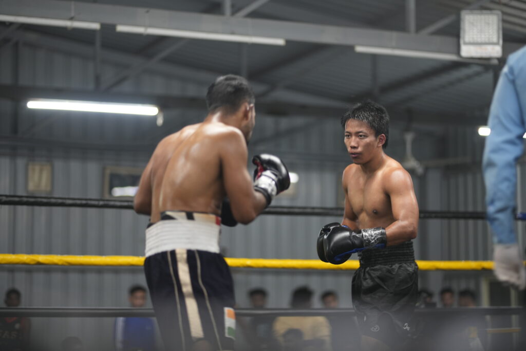 Professional boxing bout inside a boxing ring at White Corner Boxing Promotions, showcasing competitive fighters during a regulated boxing event in Bangalore.